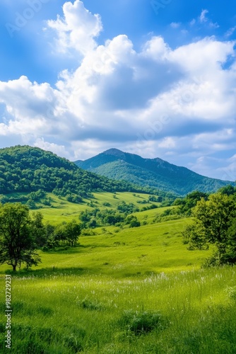 Vibrant green hills under a beautifully textured sky in the early afternoon light