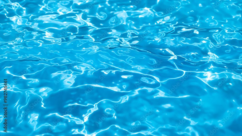 Bright Blue Water Surface Texture in Swimming Pool with Sunlight Reflections Bright Blue Water Surface Texture in Swimming Pool with Sunlight Reflections