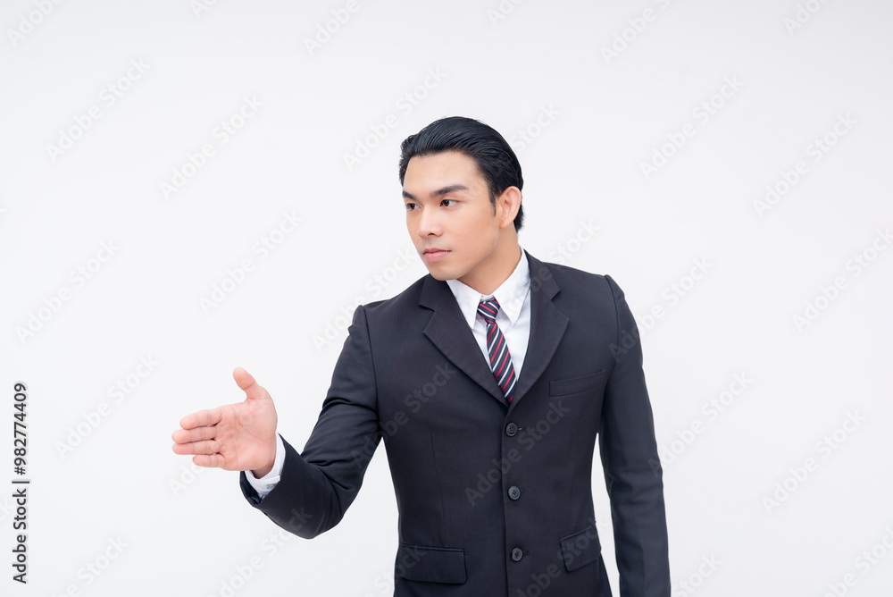 A serious young asian businessman offering a handshake after a dispute. Being professional and accepting a truce. Isolated on a white background. A serious young asian businessman offering a handshake after a dispute. Being professional and accepting a truce. Isolated on a white background.