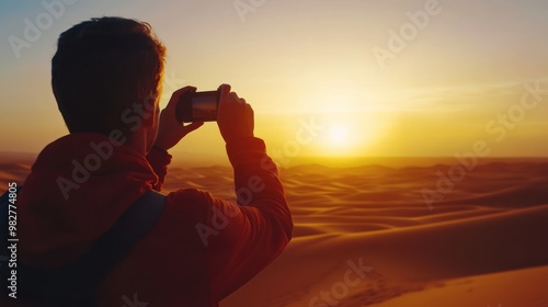 A person captures a sunset in the desert, highlighting the beauty of nature.