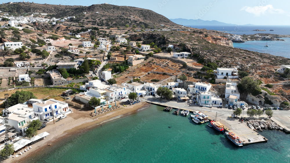 Fototapeta premium Aerial drone photo small port of Psathi untouched by tourism built below picturesque hora of Kimolos island, Cyclades, Greece