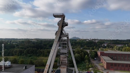 Rundflug um einen Förderturm einer alten Zeche in Gelsenkirchen am späten Nachmittag Spätsommer photo