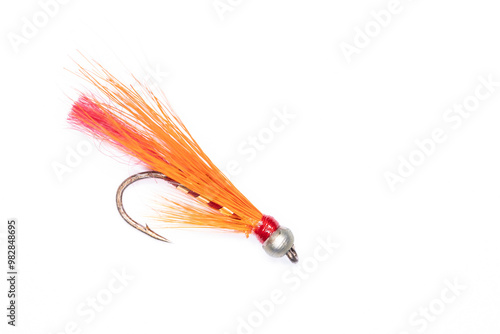 Single orange and red fishing fly isolated on white background. Concept: leisure, sport, angling, outdoors. photo