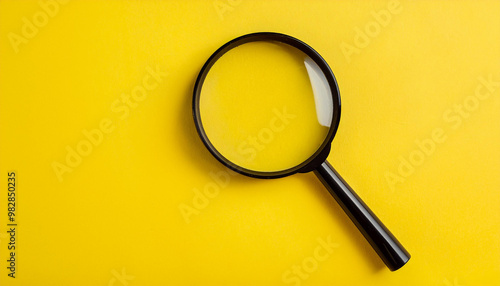 Magnifying glass on yellow background. Flat lay. Top view. Close-up.