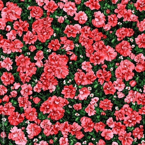 A vibrant pattern of pink flowers on a dark green background, ideal for textiles or decor.