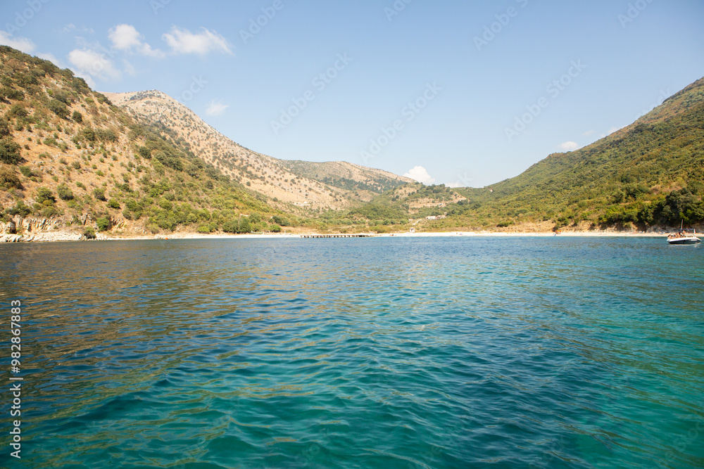 Very beautiful coastline on the Ionian Sea in Albania. The beach with fine sand in the mountains of Albania. Vacation at the sea. Very beautiful coastline on the Ionian Sea in Albania. The beach with fine sand in the mountains of Albania. Vacation at the sea.