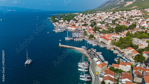 Fototapeta Naklejka Na Ścianę i Meble -  A breathtaking panorama showcases Brac Island's charming harbor, dotted with sailboats and surrounded by picturesque homes, Bol Brac Island Croatia