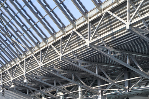 Modern architectural ceiling design with steel beams and glass panels in contemporary building interior