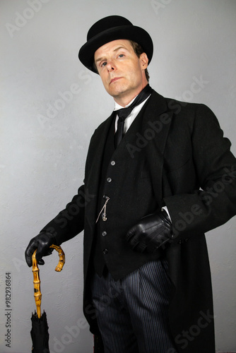Elegant Gentleman in Formal Suit and Leather Gloves Standing Proudly. Vintage Style of Classic English Gentleman.