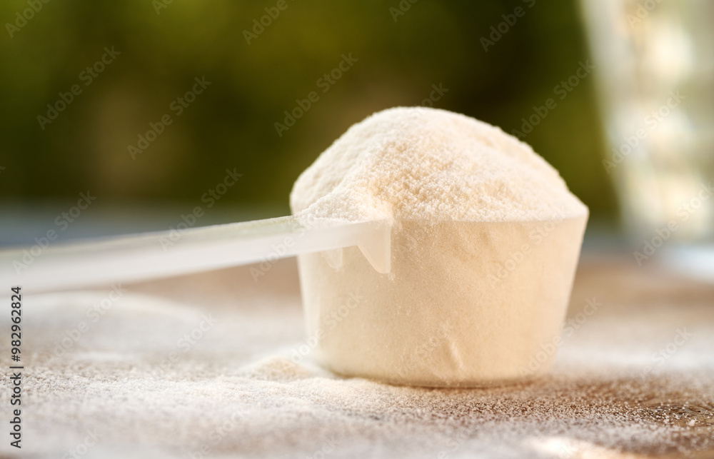 A scoop of collagen powder on a table outdoors A scoop of collagen powder on a table outdoors