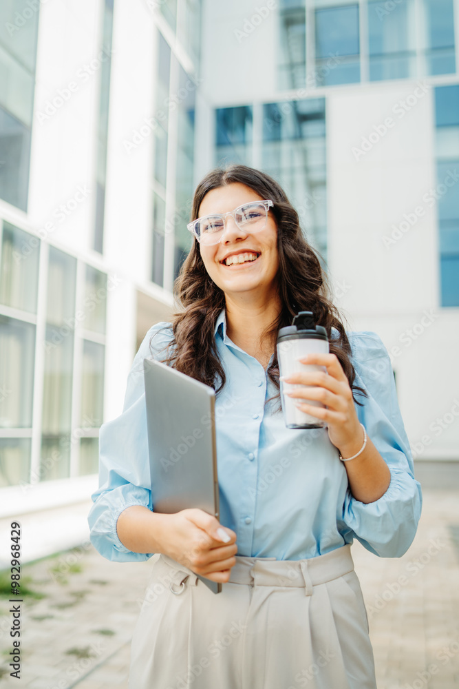 Young successful woman is going to work at modern business building Young successful woman is going to work at modern business building