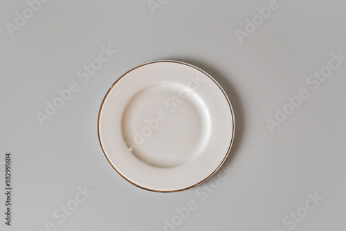 Ceramic white flat plate for food on white table top view