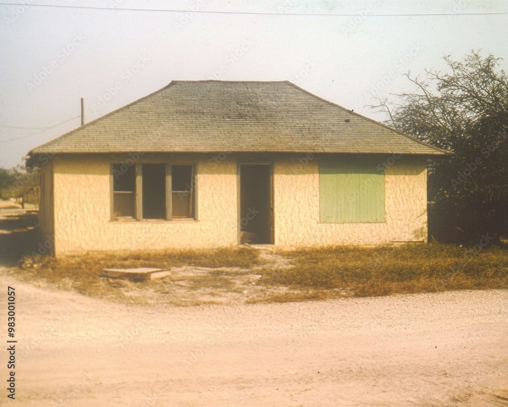 Partially Restored House Post-Disaster with Visible Repairs and Signs of Community Support Partially Restored House Post-Disaster with Visible Repairs and Signs of Community Support