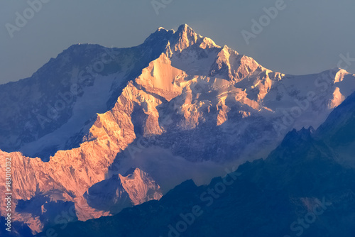Beautiful first light from sunrise on Mount Kanchenjugha, Himalayan mountain range, Sikkim, India. Orange tint on the mountains at dawn