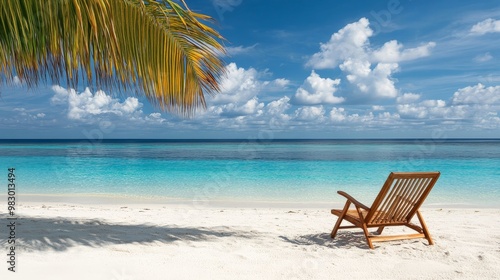 Fototapeta Naklejka Na Ścianę i Meble -  A beach chair is sitting on the sand next to the ocean