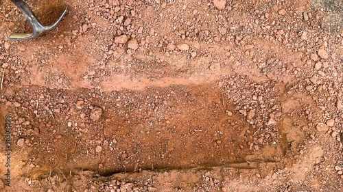 Static shot of shallow grave and shovel