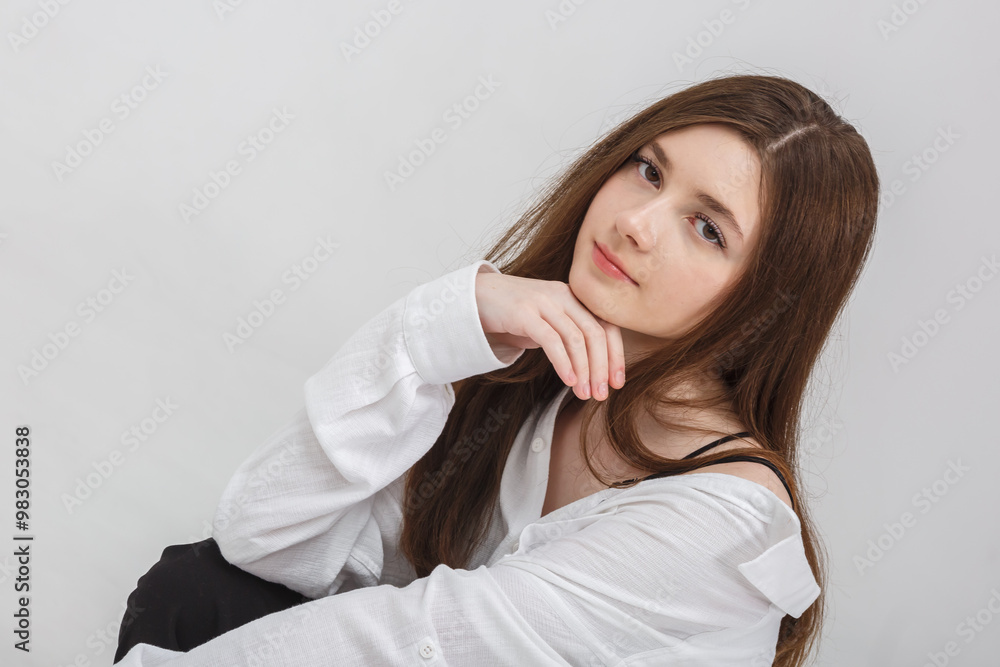 girl model in black tight-fitting dress poses in studio on white background girl model in black tight-fitting dress poses in studio on white background