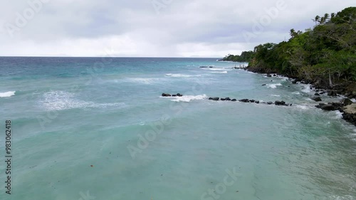 Powerful Waves Crash Against Solid Breakwater Rocks