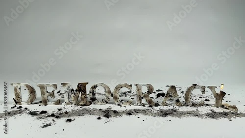Wooden letters spelling out democracy burn against white seamless background