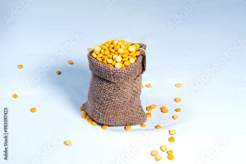fresh split peas in jute sack on white background. Chana dal