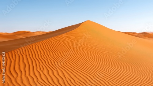 A stunning view of a solitary desert dune with rippled sand under a clear blue sky, showcasing the beauty of nature.