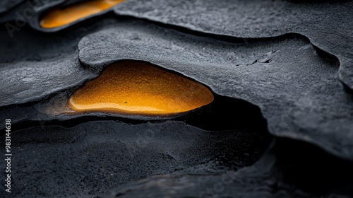  A tight shot of a rock formation displaying a yellow substance in its core The yellow substance, evidently located at the heart of the rock, adds intrigue to the scene photo