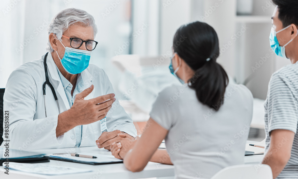 Mature, doctor and couple consultation with mask for disease diagnosis, medical results and flu virus advice. Medicine, expert and talking in clinic office for healthcare support, checkup and help Mature, doctor and couple consultation with mask for disease diagnosis, medical results and flu virus advice. Medicine, expert and talking in clinic office for healthcare support, checkup and help