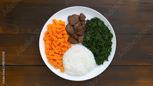 A delightful serving of gwamsi, featuring tender pork alongside rice and fresh greens, presented elegantly on a rustic wooden table photo