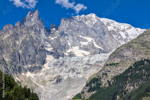 view of the mountain slope of the melting glacier brenva on the mont blanc massif near the village of courmayeur with sunny summer weather	
