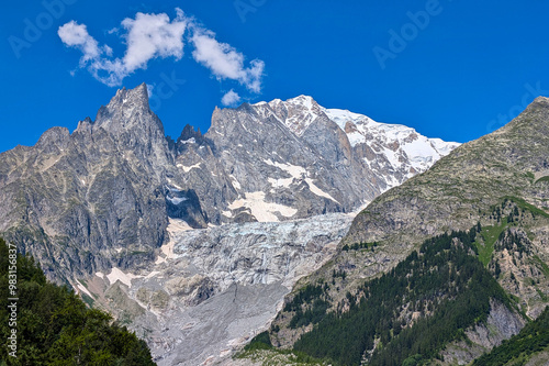 view of the mountain slope of the melting glacier brenva on the mont blanc massif near the village of courmayeur with sunny summer weather