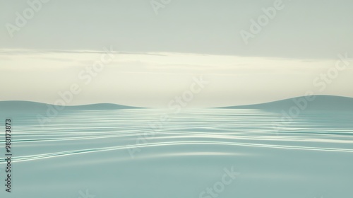 Calm and serene water surface reflecting soft clouds under a hazy sky during twilight