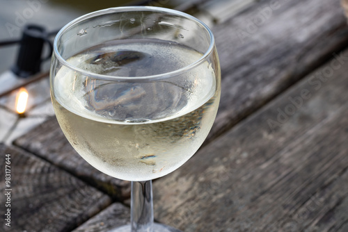 Tasting of Bordeaux white wine, right bank of Gironde Estuary, France. Glasses of white sweet French wine served in outdoor restaurant photo