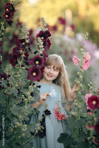 A girl in the mallow flower garden