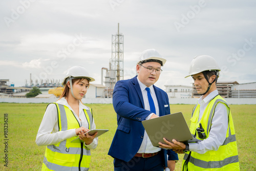 Asian managers and engineers inspect work in front of the company. photo