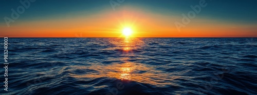 Beautiful sunset over the ocean showcasing vibrant colors and calming waves i...