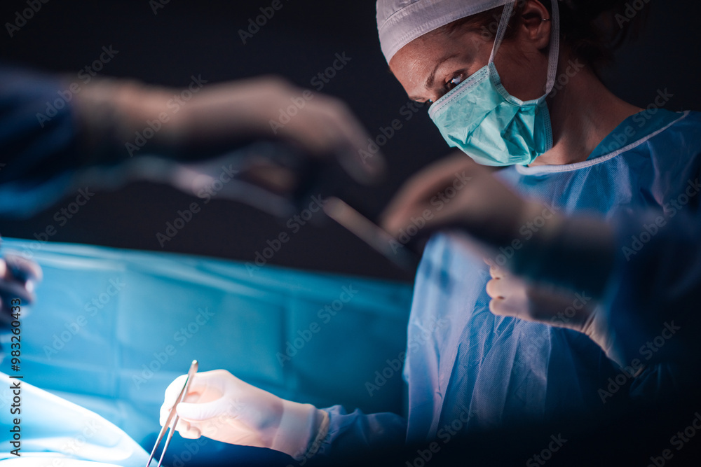 Surgeons in action during a complex surgical operation in OR. Surgeons in action during a complex surgical operation in OR.