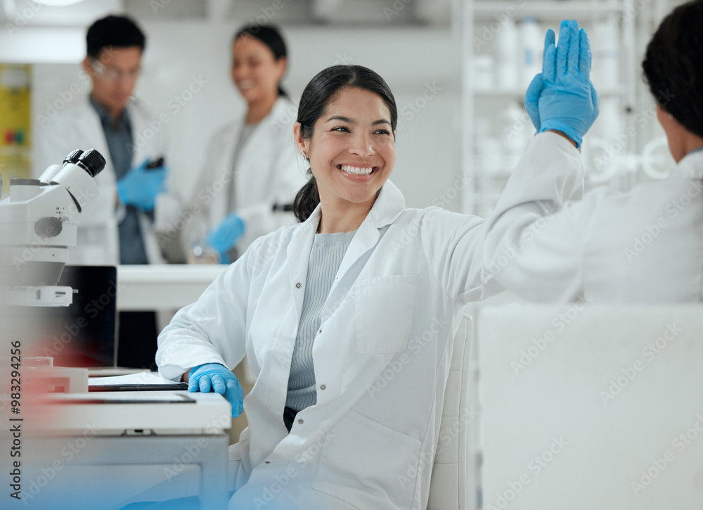 © KayExam/peopleimages.com - High five, success and happy woman in laboratory for science breakthrough, clinical trial or discovery. Goals, medical target or scientist with innovation for vaccine research, cure or development