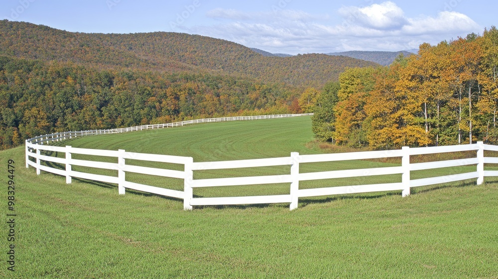 A beautiful horse pasture features a white wooden fence, surrounded by colorful trees in vibrant fall hues against a backdrop of rolling hills under a cloudy sky A beautiful horse pasture features a white wooden fence, surrounded by colorful trees in vibrant fall hues against a backdrop of rolling hills under a cloudy sky
