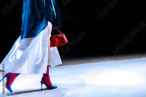 Elegant outfit, white long skirt, high heels and red handbag