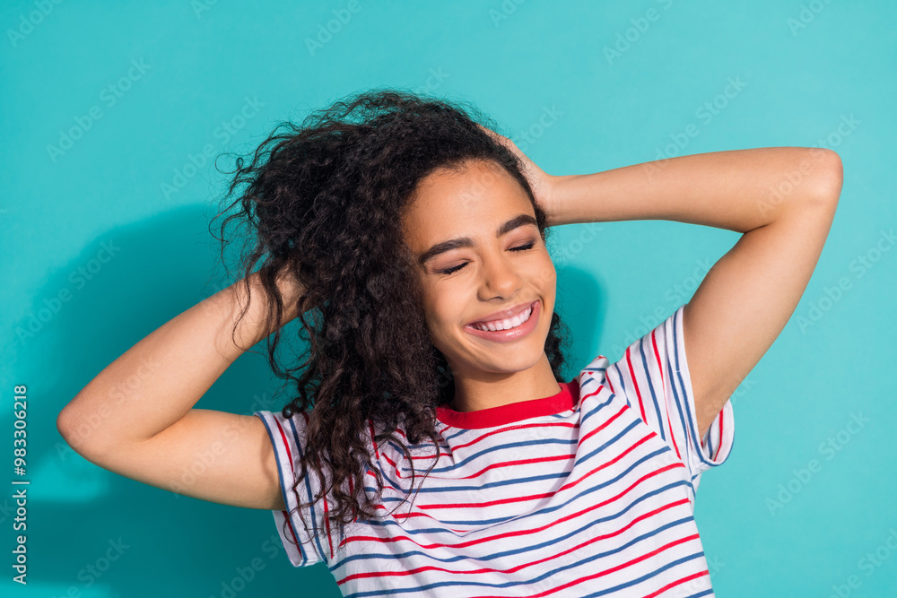 Photo portrait of attractive young woman touch hair shampoo dressed stylish striped clothes isolated on aquamarine color background Photo portrait of attractive young woman touch hair shampoo dressed stylish striped clothes isolated on aquamarine color background