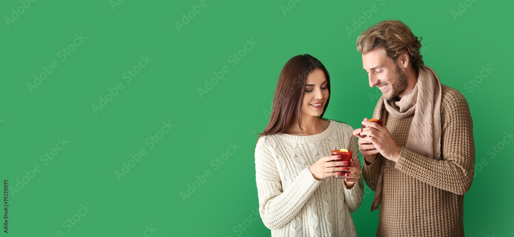 © Pixel-Shot - Couple with delicious mulled wine on color background