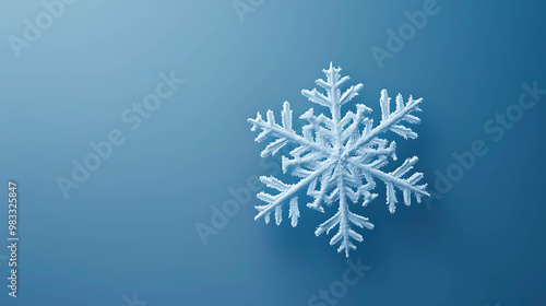 A single, delicate snowflake on a blue background.