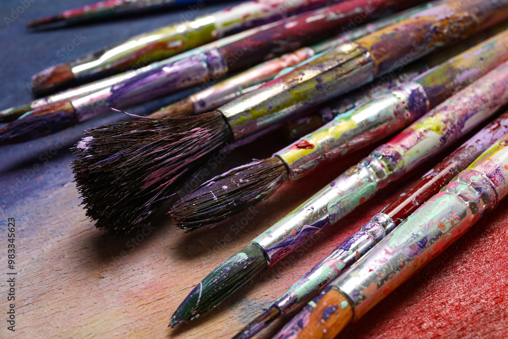 Dirty paint brushes on colorful background Dirty paint brushes on colorful background
