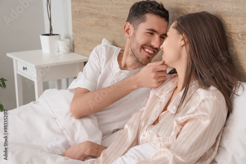 Smiling young couple lying ...