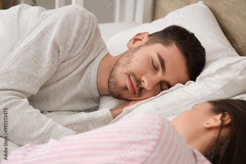 Young couple sleeping in bed