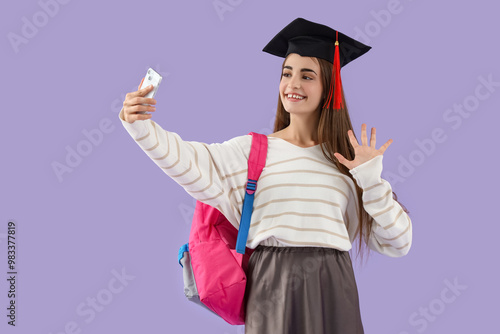 Happy female student in gra...