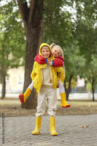Happy children with raincoa...