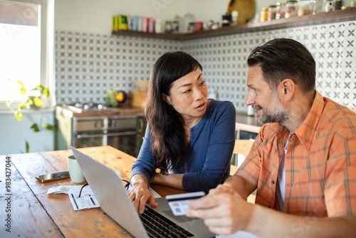 Couple managing finances online using credit card