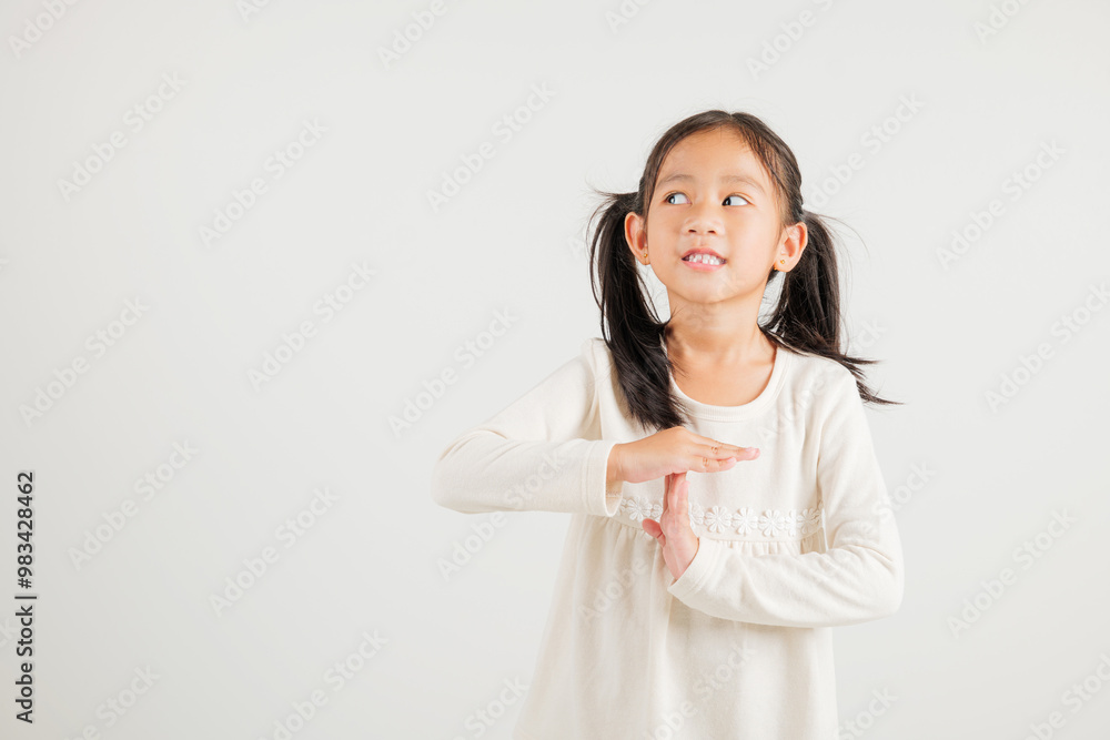 Closeup portrait young kid girl smiling making give time out gesture with hands studio shot isolated on white background, kindergarten child demonstrates break hand sign, stop time with copy space Closeup portrait young kid girl smiling making give time out gesture with hands studio shot isolated on white background, kindergarten child demonstrates break hand sign, stop time with copy space