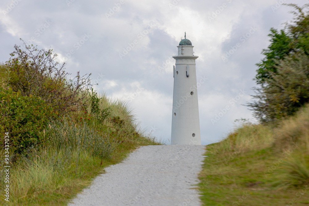The white lighthouse with dunes gravel path, The south tower (Zuidertoren) or water tower, Schiermonnikoog is a municipality and national park in Northern Netherlands, One of the West Frisian Islands. The white lighthouse with dunes gravel path, The south tower (Zuidertoren) or water tower, Schiermonnikoog is a municipality and national park in Northern Netherlands, One of the West Frisian Islands.